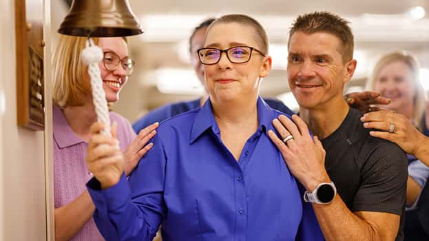Cancer survivor ringing the bell after treatment