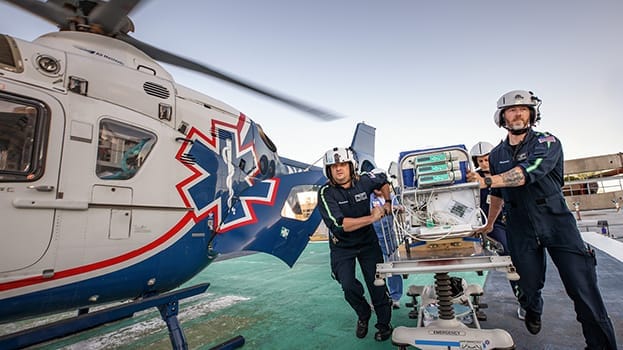Two Medflight paramedics escorting a gurney
