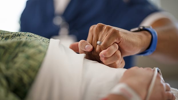 Two people holding hands