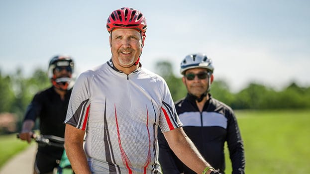 3 male cyclists smiling for a photo